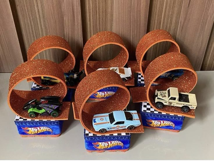 there are many toy cars stacked on top of each other in the shape of letters