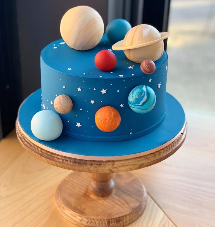 a cake with planets on it sitting on top of a wooden table