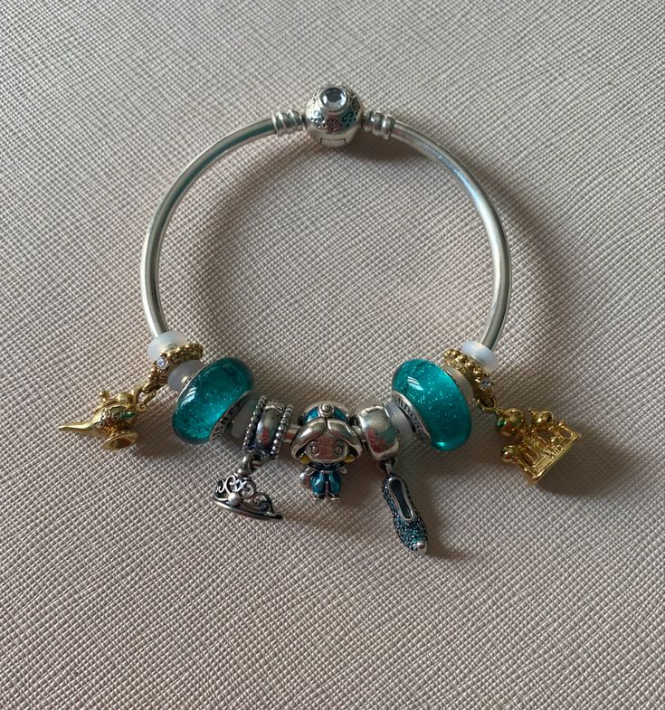 a bracelet with charms on it sitting on a table