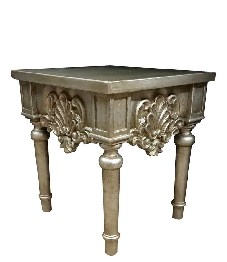 an ornately carved table with two legs and a square top on one leg, is shown