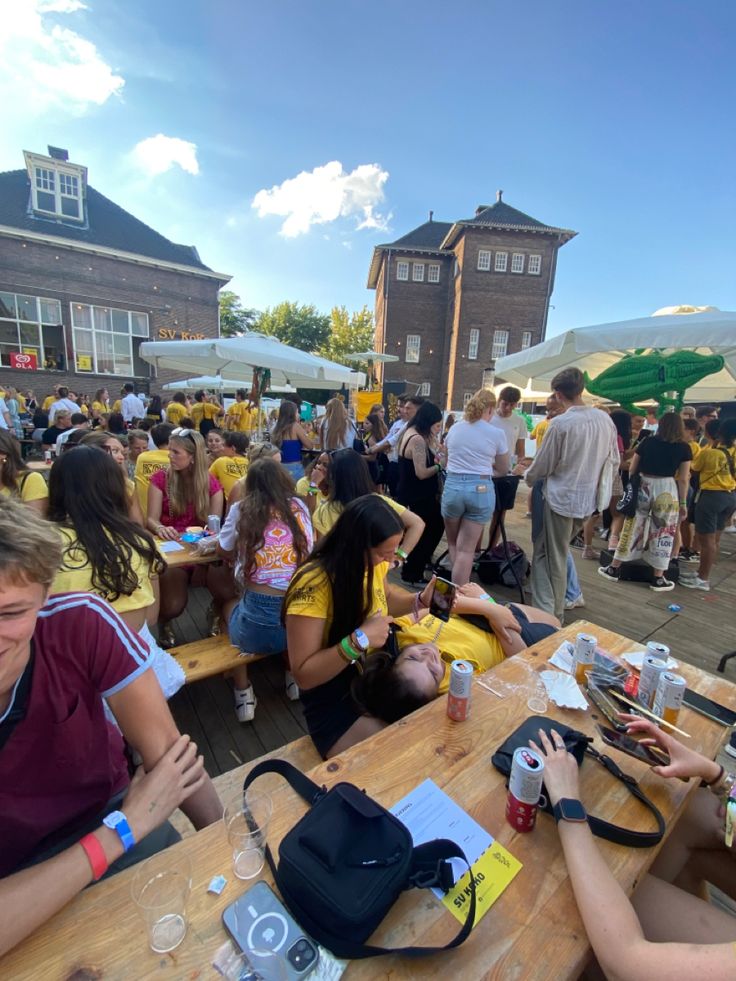 a group of people sitting at wooden tables