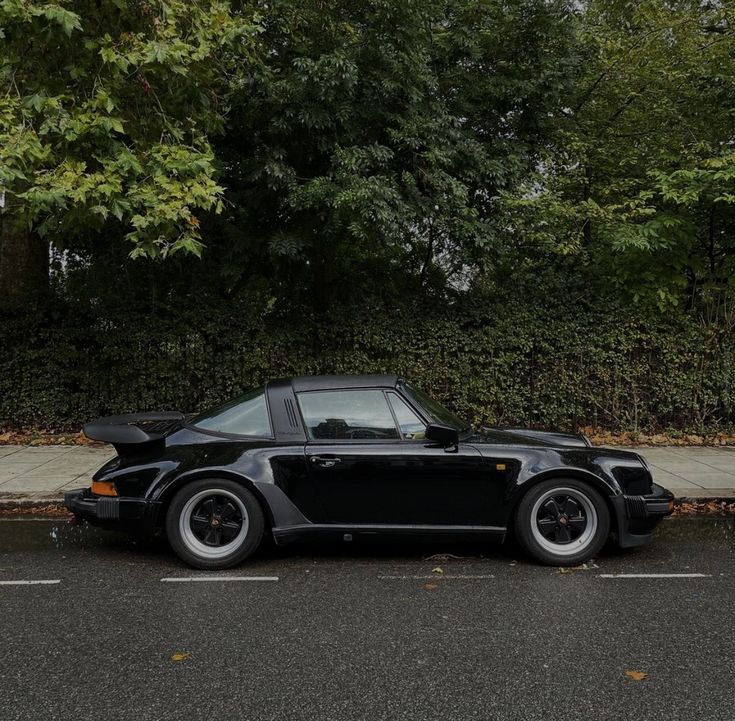 a black car parked on the side of a road