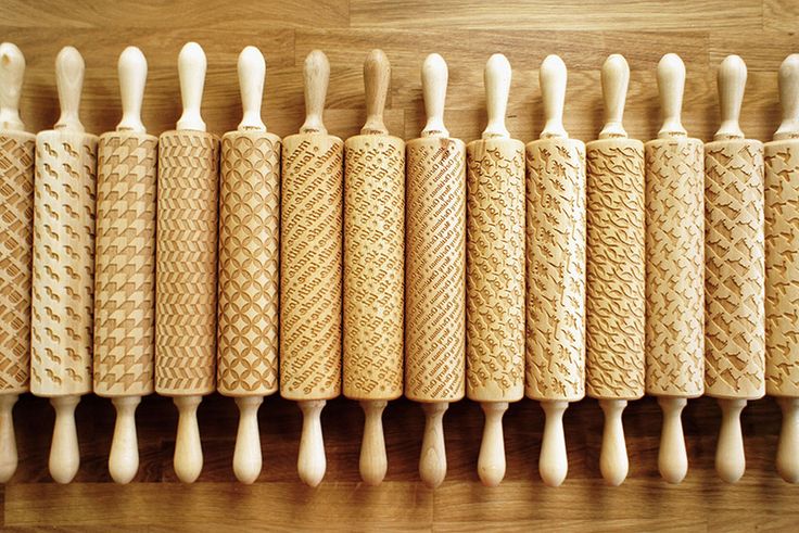 a row of wooden toothbrushes sitting on top of a wooden table next to each other