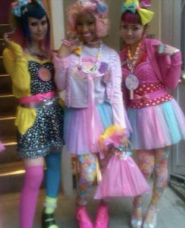 three girls dressed in costumes posing for the camera