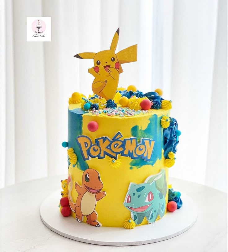 a pokemon themed birthday cake with pikachu and eena on it's side