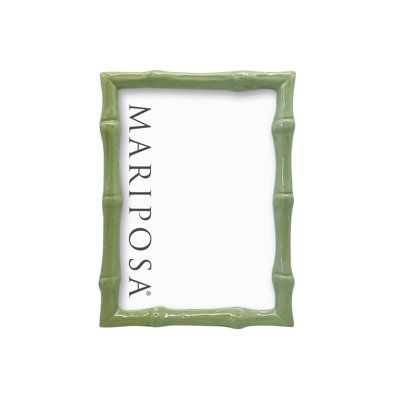 a green bamboo frame with the words marjosa written in black ink on it