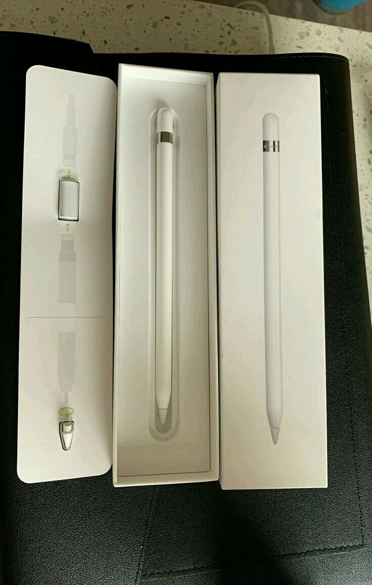 an open box with a white apple pen in it