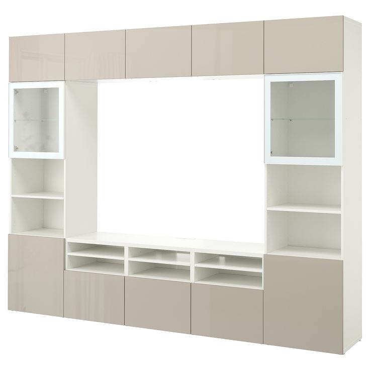 a white and beige entertainment center with shelves on each side that has a large mirror above it