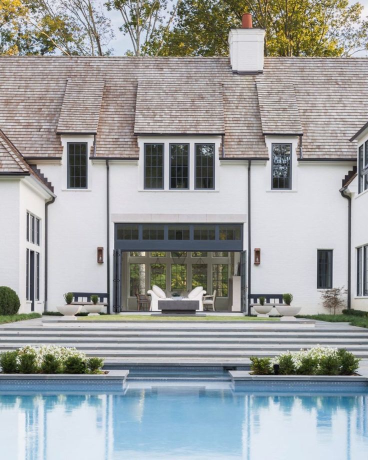 a large white house with a pool in the front yard