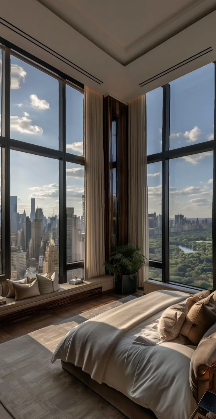 a bedroom with large windows overlooking the city