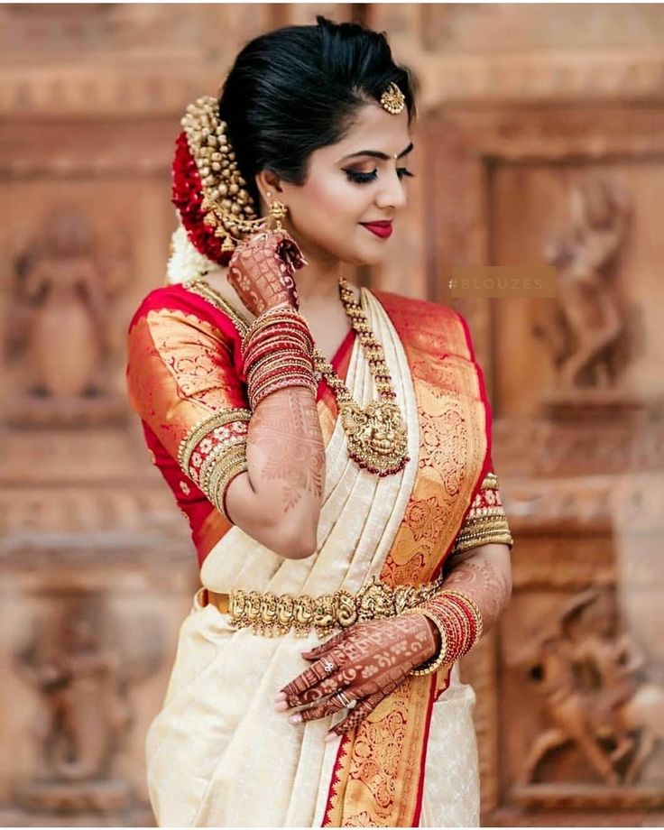 a woman in a white and red sari