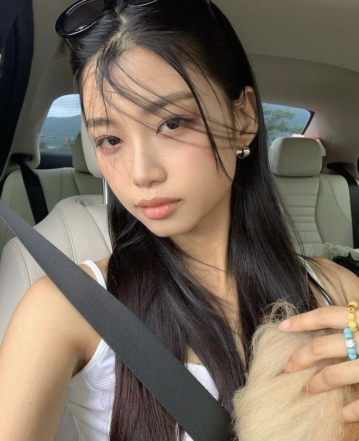 a young woman sitting in the back seat of a car