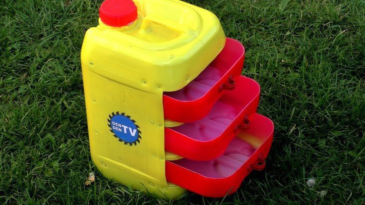 three plastic containers stacked on top of each other in the grass