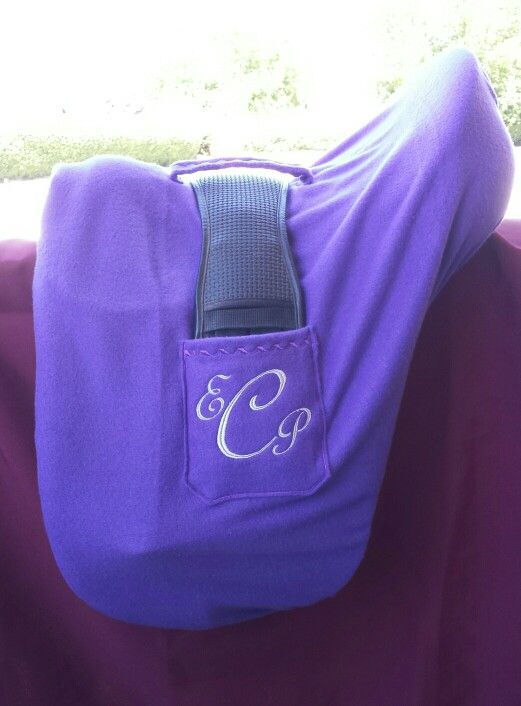 a purple horse blanket with the letter c in white on it's back pocket