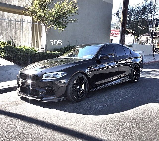 a black car parked in front of a building