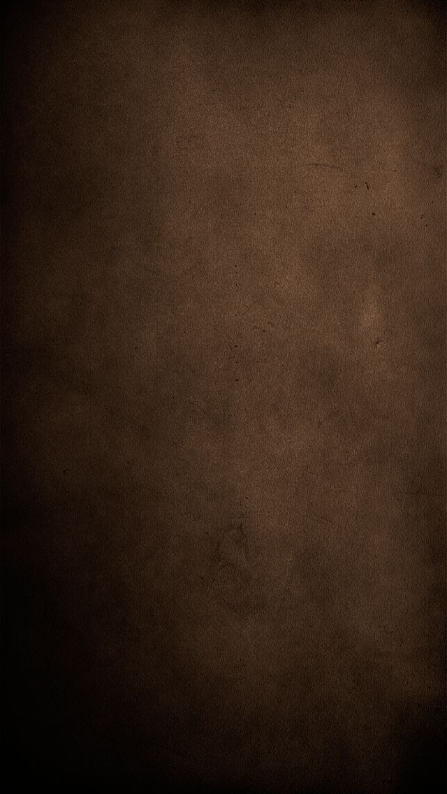 a dark brown background with some stains on it