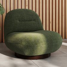 a green chair sitting on top of a cement floor next to a potted plant