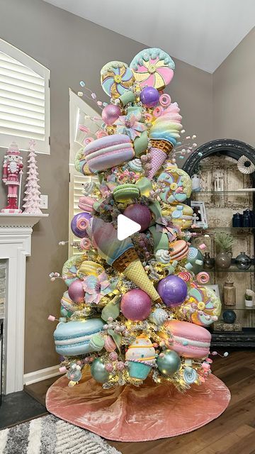 a decorated christmas tree in the middle of a living room with lots of decorations on it