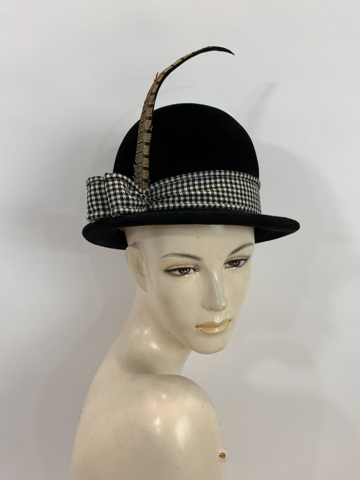 "\"It's not the shape of a woman's face that really decides, but the attitude of the hat\" Frank Olive And this hat has some attitude! Black velvet bowler style with a wool black and white houndstooth ribbon band, that end at the right side with a two loops and a long pheasant feather. inside is a smooth wool felt with a pink grosgrain band. Label: Frank Olive Bloomingdales New York Stamped: Cotillion Imported Made in France 20\" circumference around inner grosgrain band 6\" high with an 1.5\" b Vintage Top Hat With Short Brim For Fall, Vintage Short Brim Top Hat For Fall, Vintage Top Hat For Fall Party, Vintage Fall Mini Hats, Vintage Formal Hat For Fall, Retro Black Brimmed Mini Hat, Black Retro Brimmed Mini Hats, Vintage Wide Brim Mini Hat For Fall, Black Retro Mini Hat With Short Brim