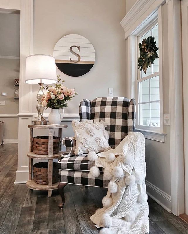 a living room filled with furniture and a large clock on the wall above it's windows