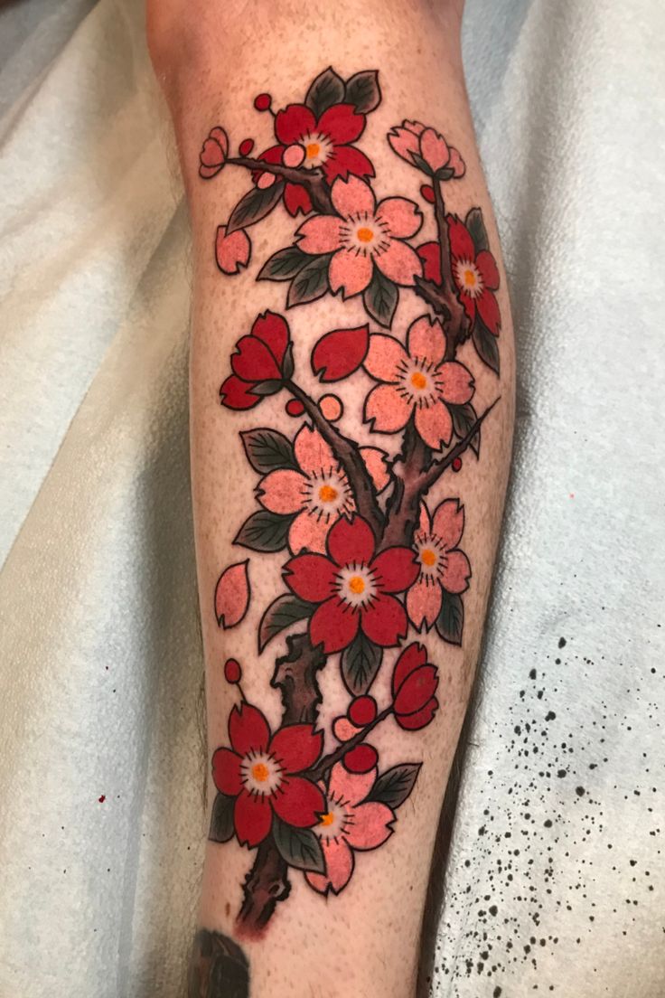 a person with a flower tattoo on their leg