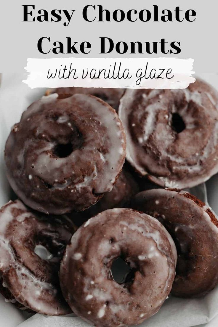 chocolate cake donuts with vanilla glaze are in a white box on a table