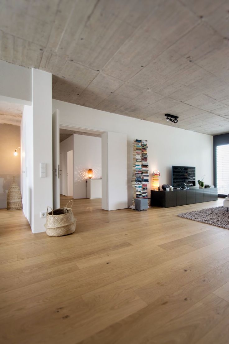 a living room with hard wood floors and white walls