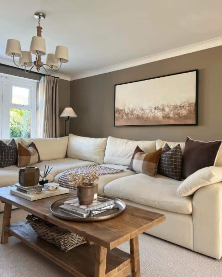 a living room filled with furniture and a painting on the wall above it's coffee table