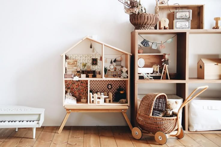 a doll house sitting on top of a wooden shelf next to a white bench and chair