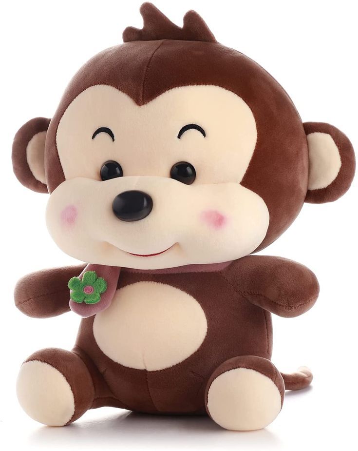 a stuffed monkey with a clover in its mouth