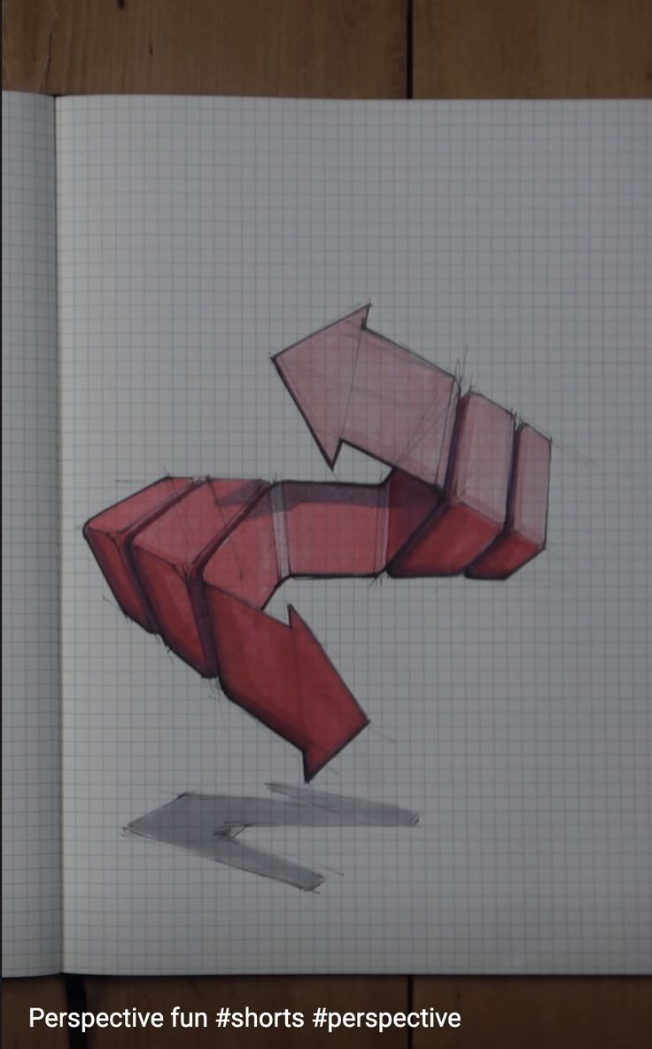 an open notebook with a drawing of a red arrow in the shape of a rectangle