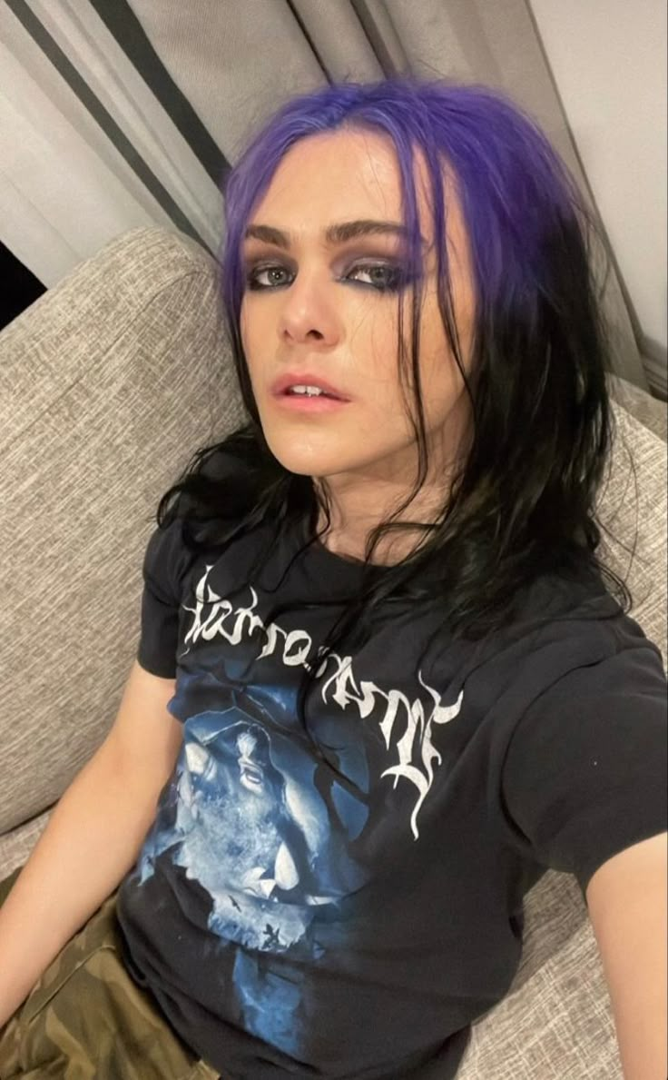 a woman with purple hair sitting on a couch