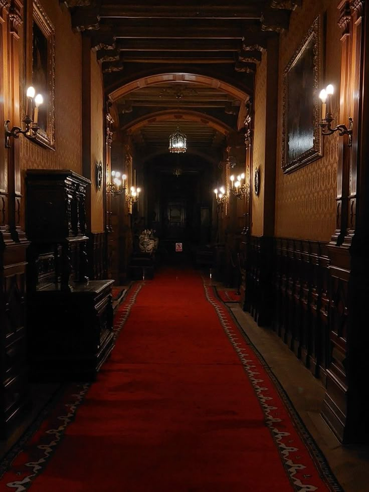 an empty hallway with red carpet and lights