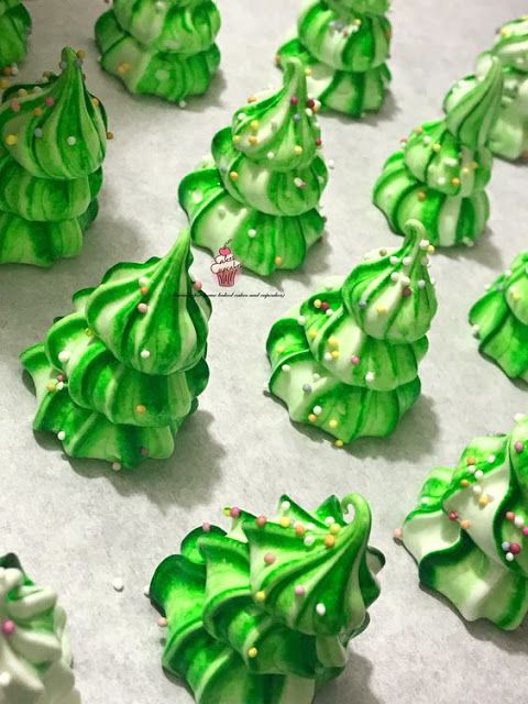 green and white christmas tree cookies on a baking sheet