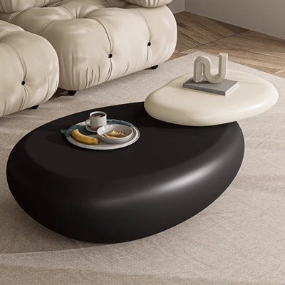 a living room with a white couch and black coffee table on the carpeted floor