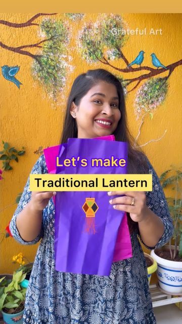 a woman holding up a purple bag that says let's make traditional lanternern