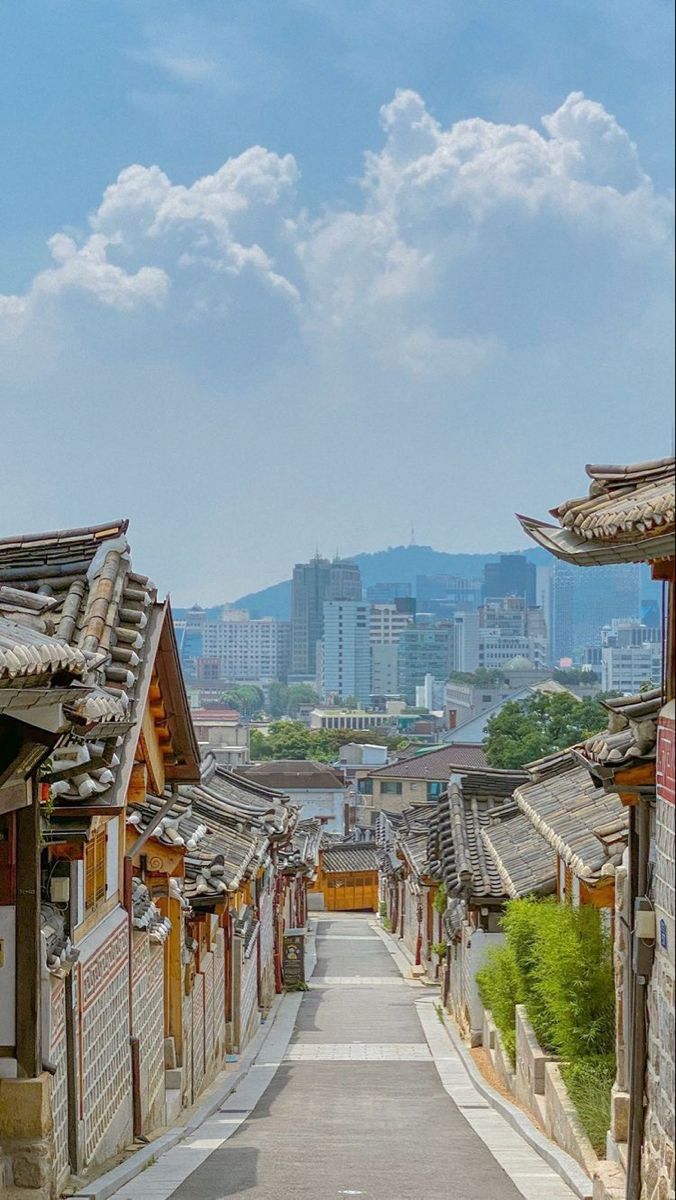 an empty street with buildings and mountains in the background on a sunny day, china