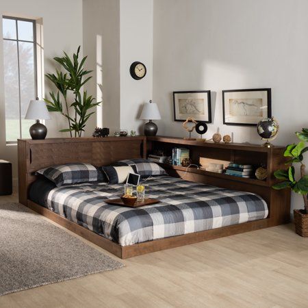 a bed room with a neatly made bed and two planters on the nightstands