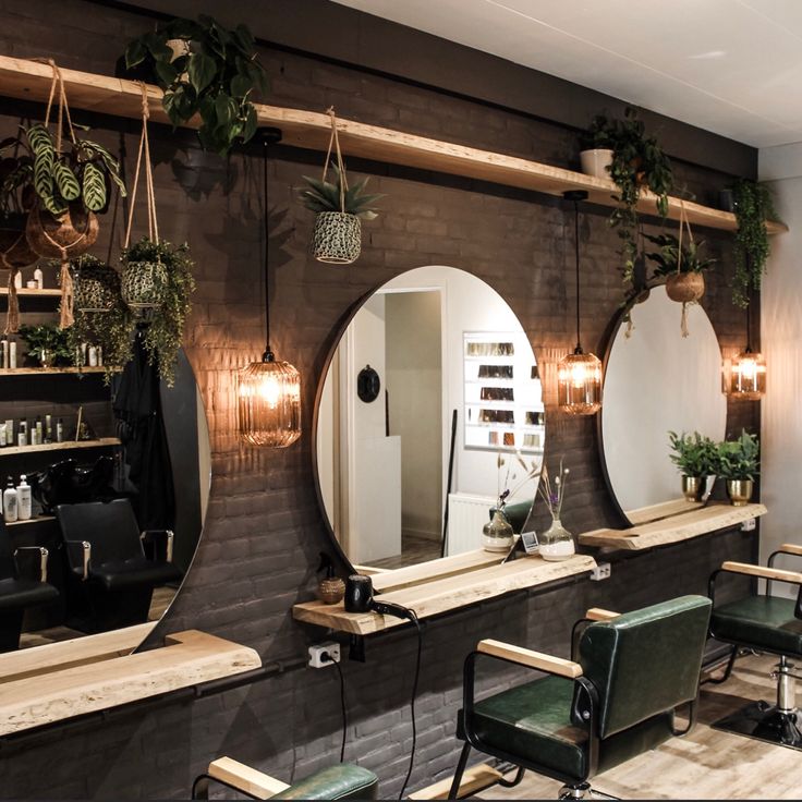 a hair salon with mirrors, chairs and plants on the wall in front of it