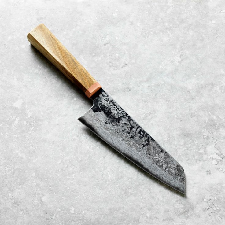 a knife with a wooden handle sitting on top of a table