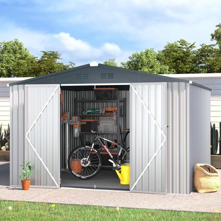 a bike is parked in the side of a metal shed