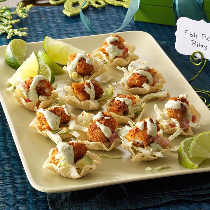 some food is sitting on a plate with limes and other items around the table