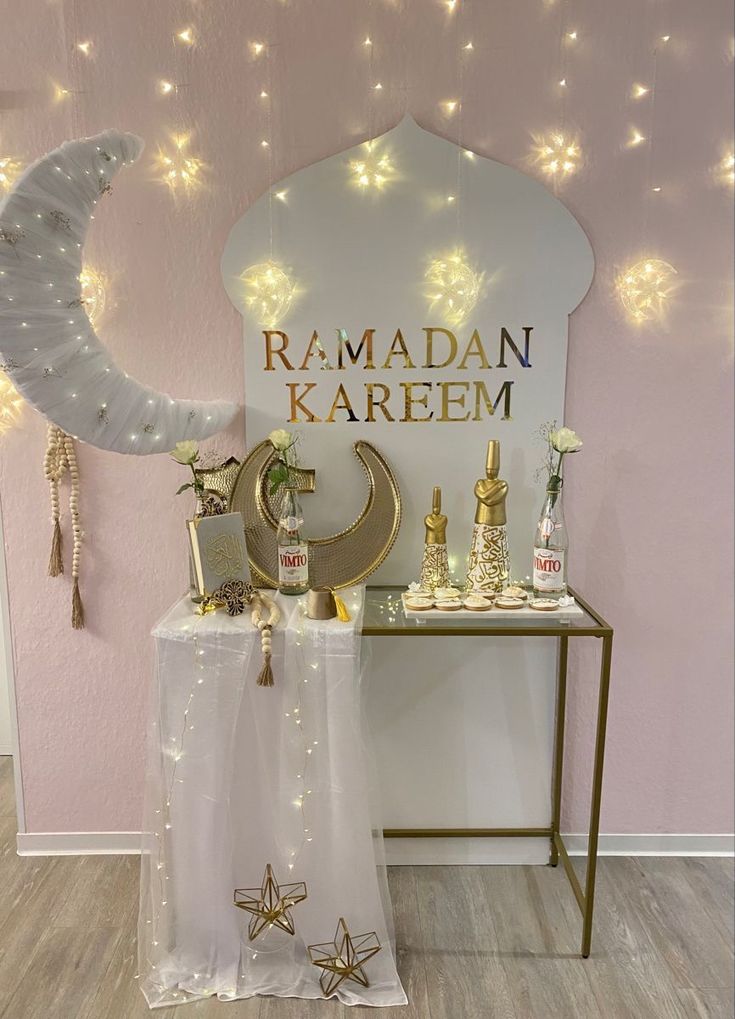 a room decorated in gold and white with lights on the wall, stars and moon decorations