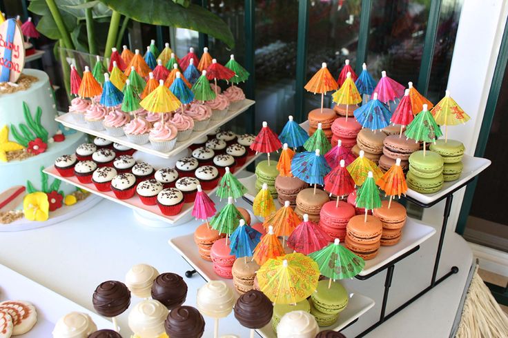 an assortment of desserts and cupcakes on a table