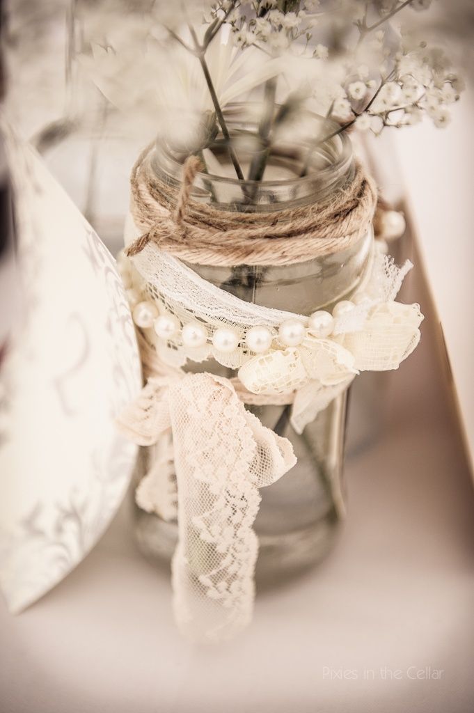 a glass jar with some flowers in it