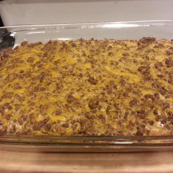 a casserole dish with meat and cheese in it sitting on a counter top