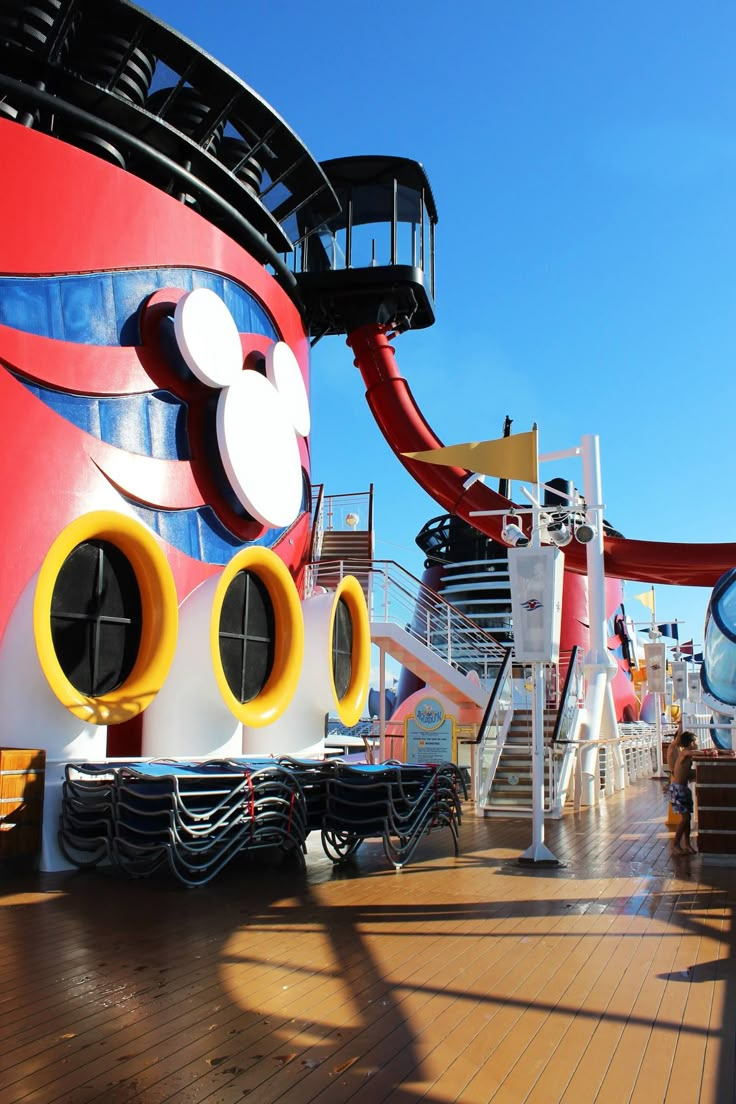 the deck of a cruise ship with mickey mouse's head on it and other decorations