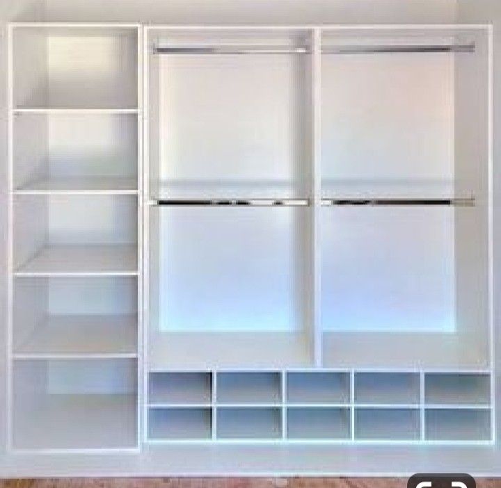 an empty white closet with shelves and drawers