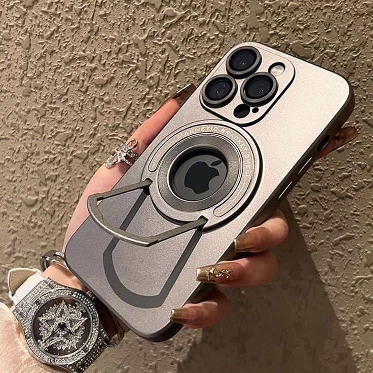 a woman's hand holding an iphone case with a camera attached to the back