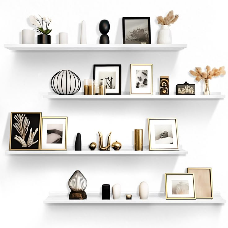 two white shelves filled with pictures and vases